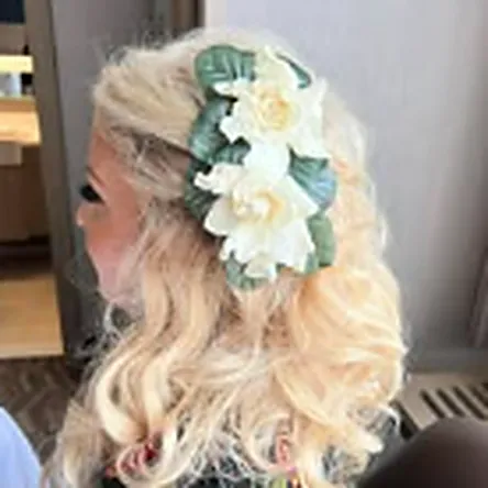 Bridal half-up style finished with fresh florals